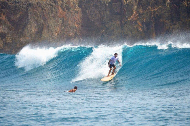 The island of Siargao is famous for its surf and for being the surfing capital of the Philippines.  Regarding access, it can only be reached through domestic flights.